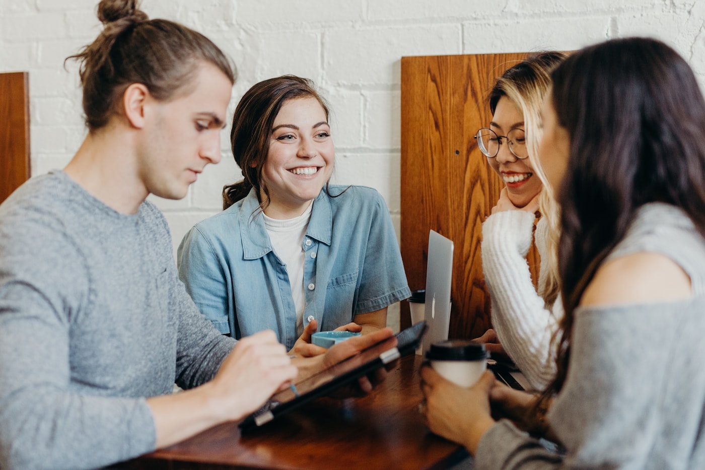 Friends gathered around a community table at the café