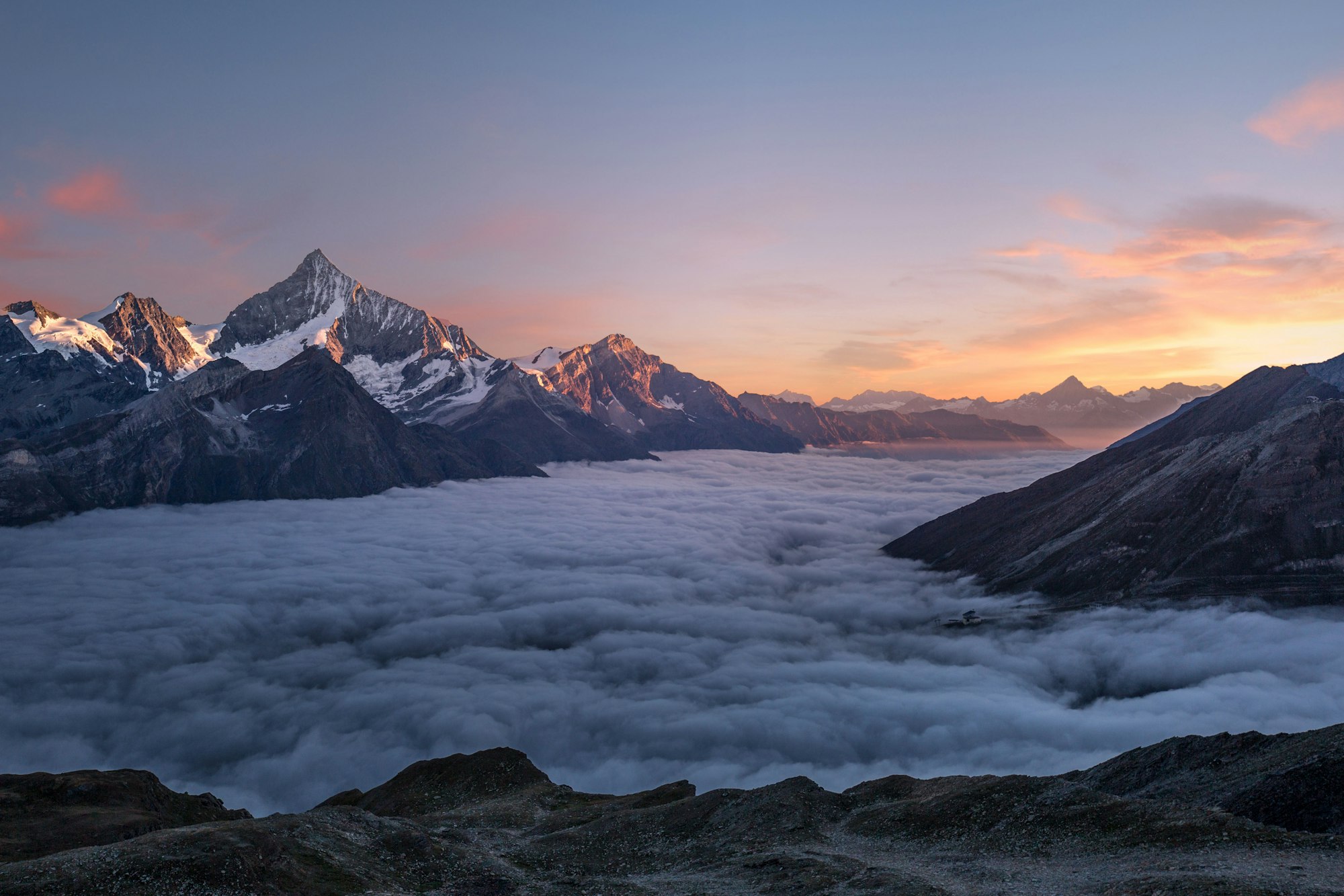 Himalayan peaks at sunrise above a sea of clouds