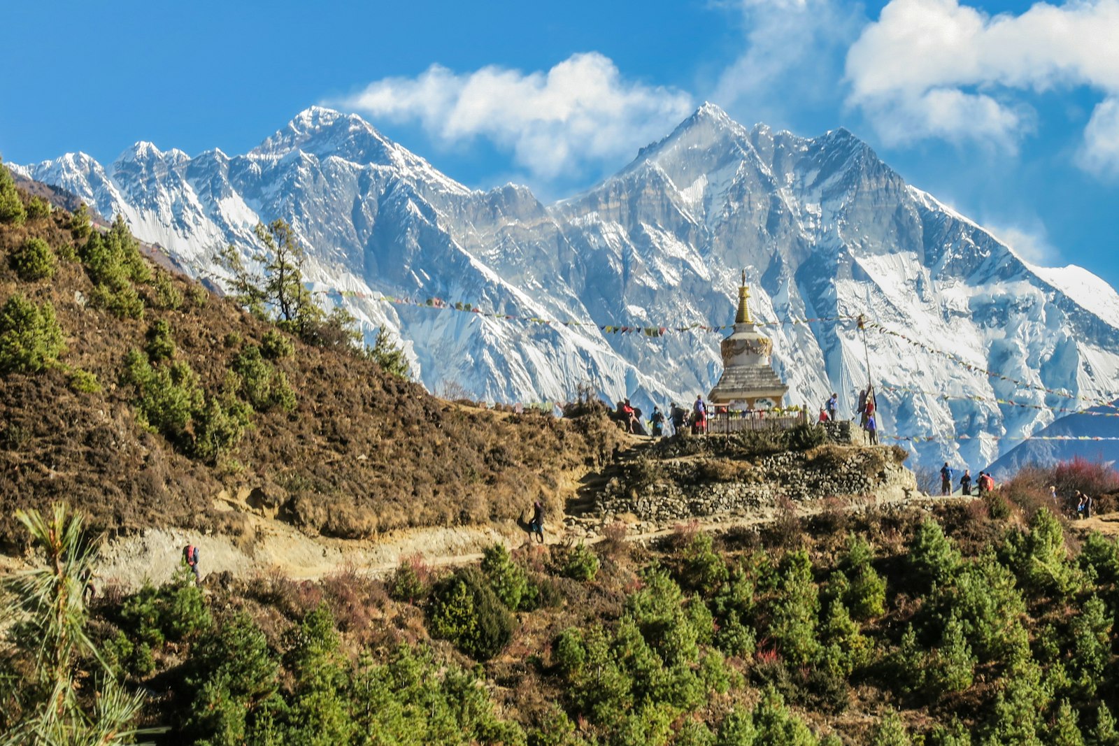 A stupa on a trail beneath snowbound Himalayan peaks